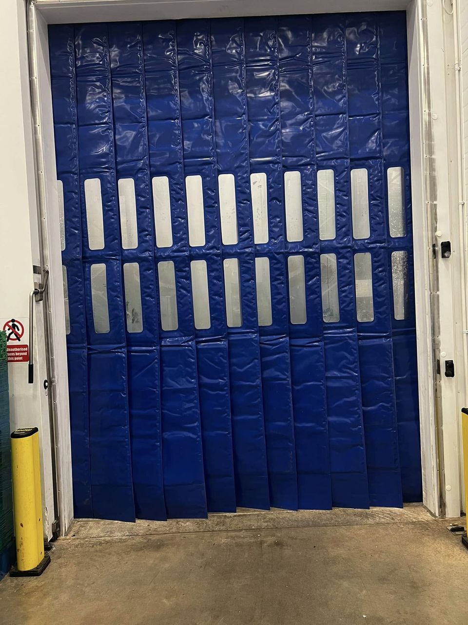 Insulated freezer curtains fitted to a freezer doorway