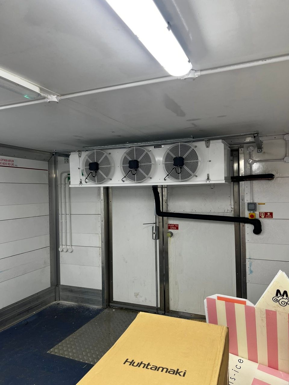 Freezer evaporator installed above the freezer room door