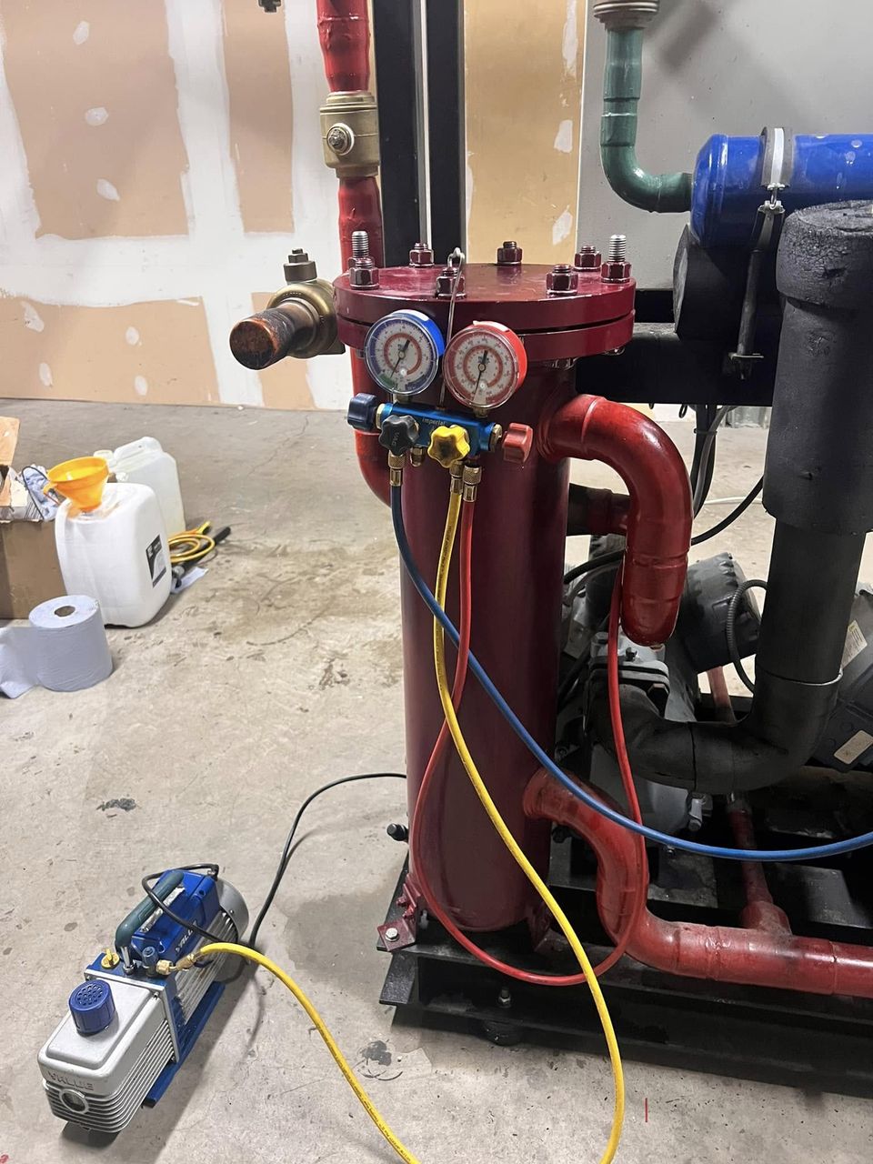 Manifold gauges connected to a pack during servicing